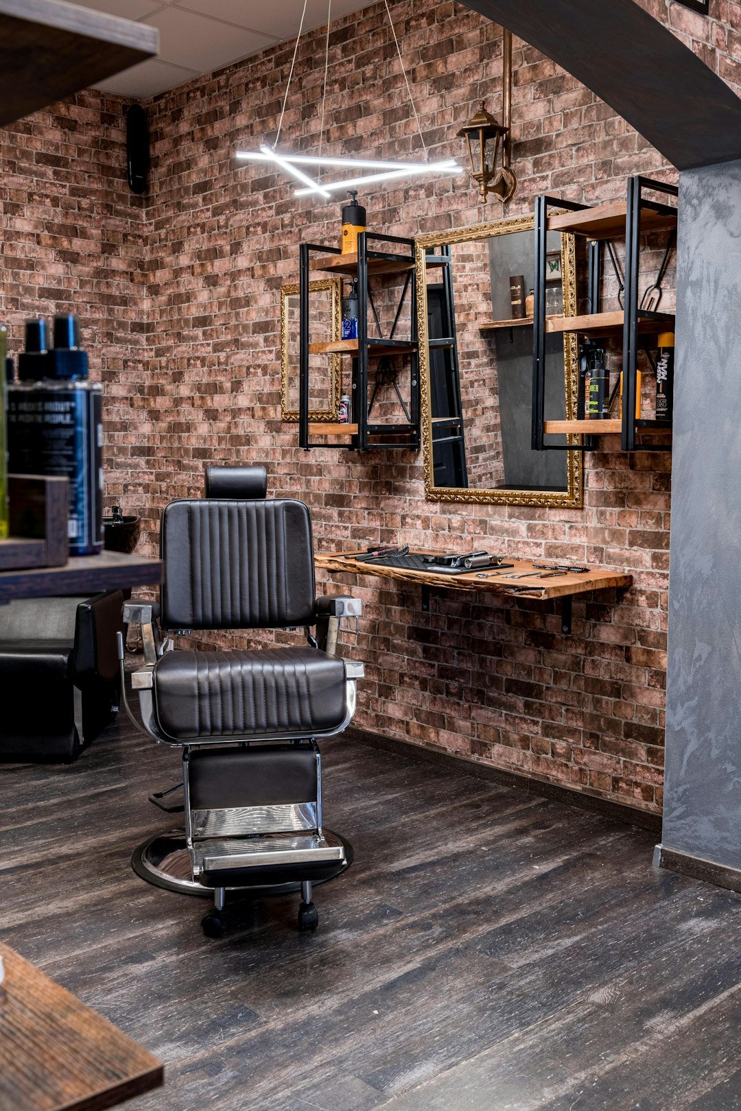 a-barber-shop-with-a-brick-wall-and-wooden-floors-k6rsu8om2ue