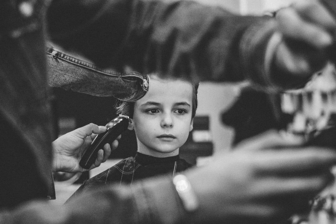 grayscale-photo-of-boy-having-haircut-vdkqo0vvsia